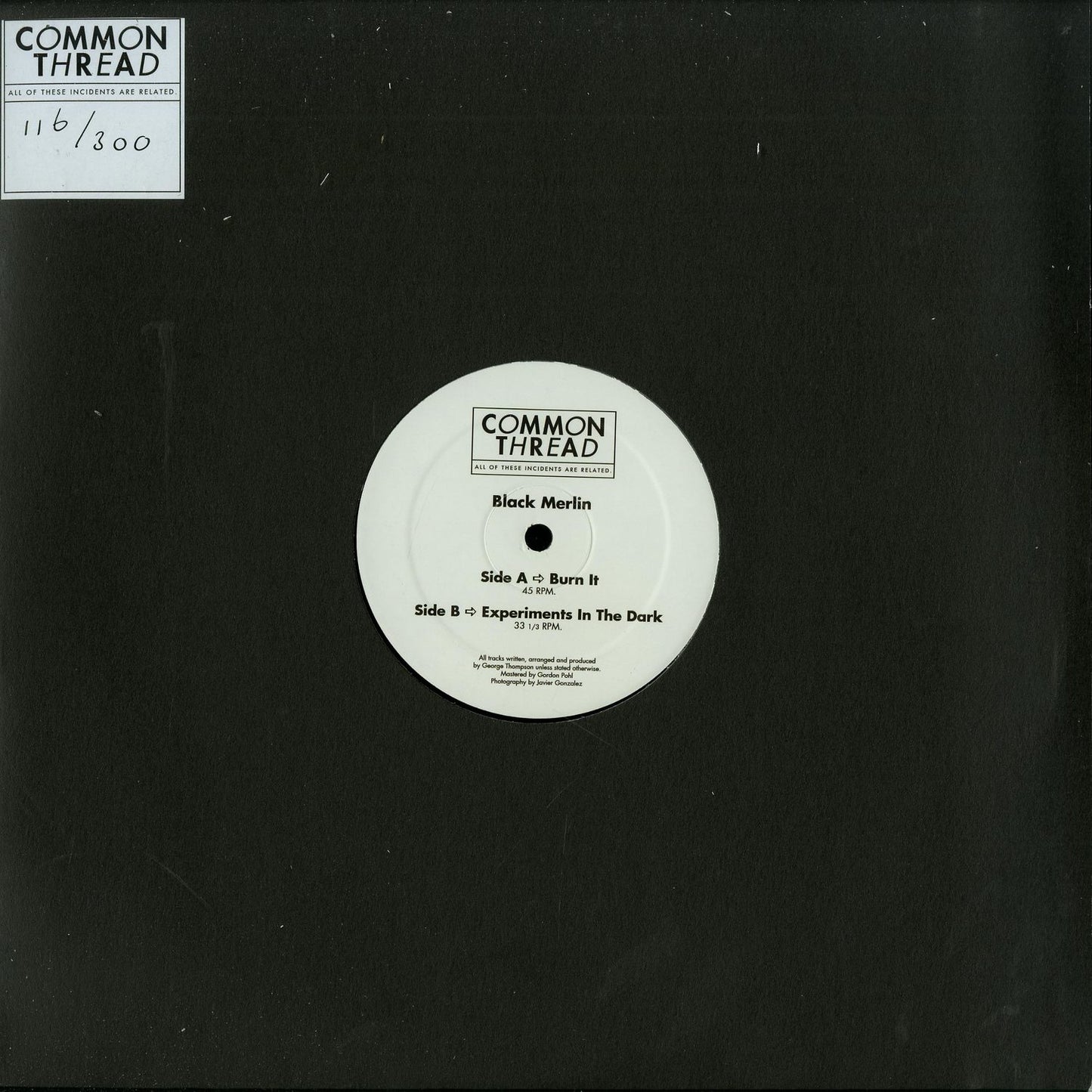 Black Merlin vinyl record titled "Burn It / Experiments in the Dark" with dark cover art and minimal text, second hand condition.
