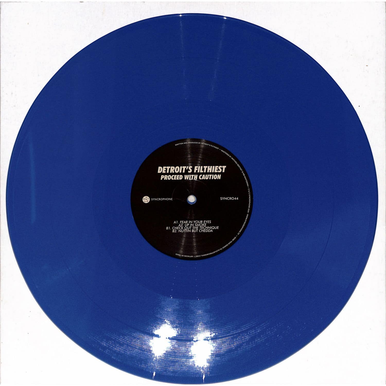 Syncrophone vinyl record of Detroit's Filthiest – Proceed with Caution, featuring dark, gritty album artwork on the front.