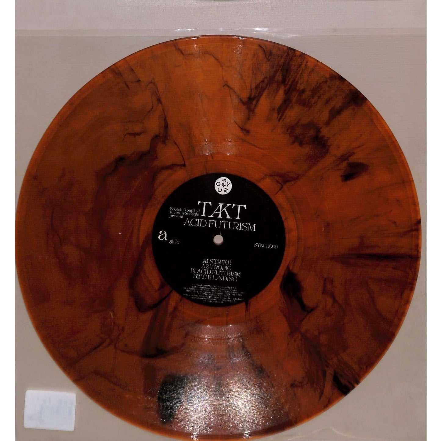 Vinyl record titled "Acid Futurism" by Satoshi Tomiie & Kamran Sadeghi, displayed with album cover art on a turntable.