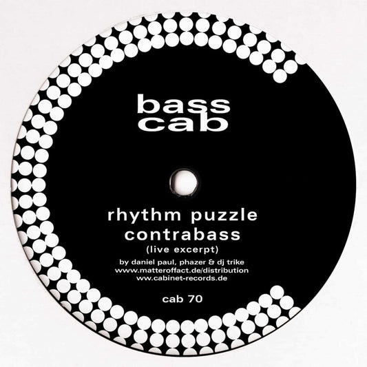 Decks BASS CAB – RHYTHM PUZZLE vinyl record with colorful abstract album artwork and the record partially visible in the image.