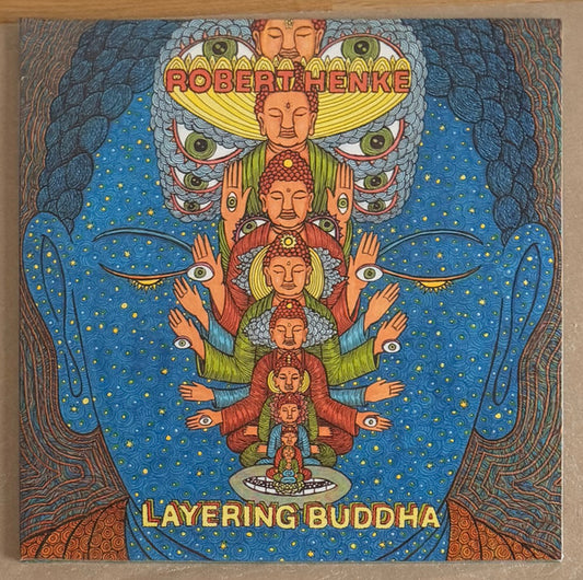 Vinyl record "Layering Buddha" by Robert Henke, released by Space Cadets, showing the front cover with abstract artwork.