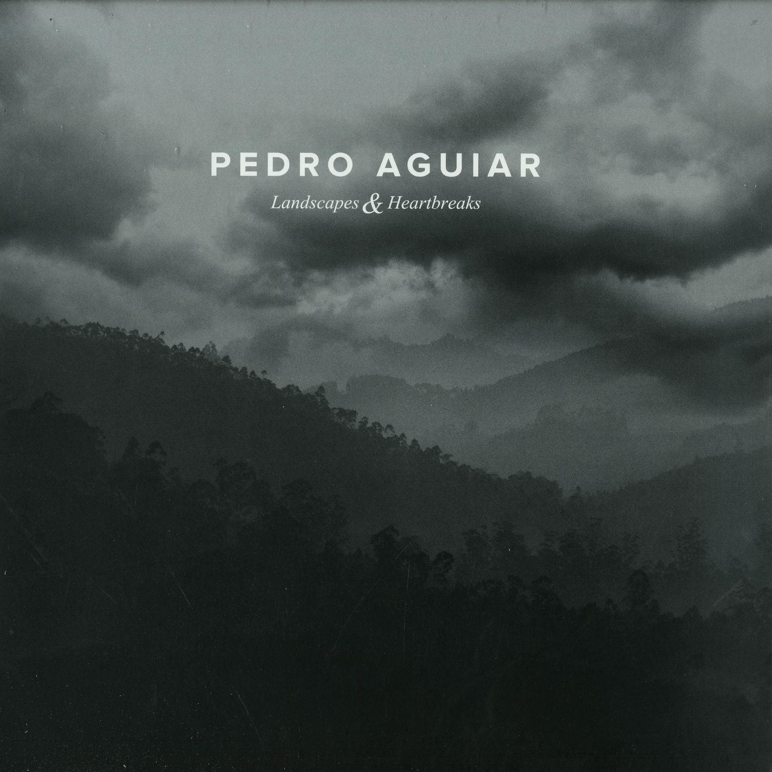 Second Hand vinyl record of Pedro Aguiar's "Landscapes & Heartbreaks" featuring album cover art with colorful landscape and heart imagery.